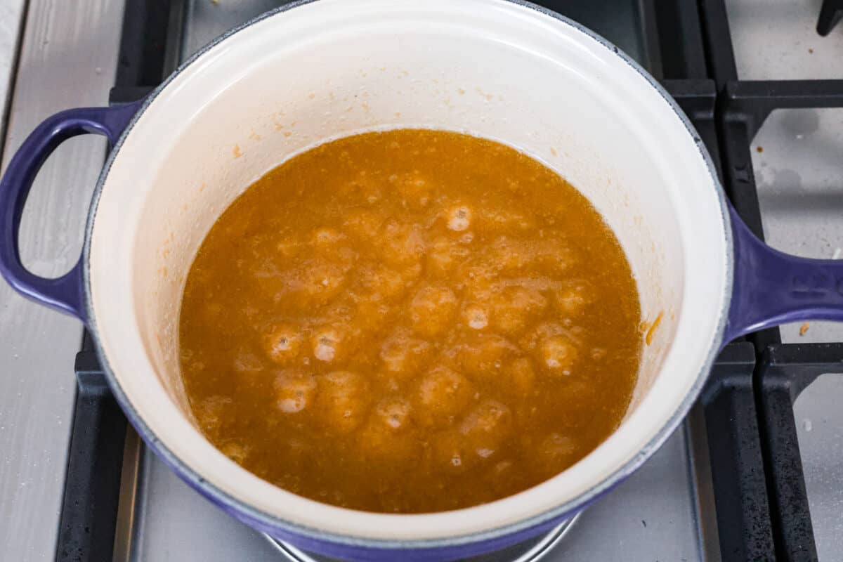 boiling brown sugar and butter in a saucepan, ready to make churro crack. 