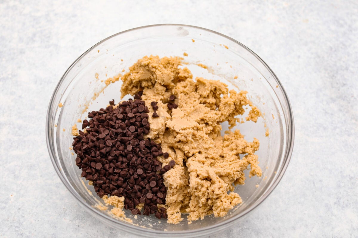 Overhead shot of a bowl with mixed ingredients and mini chocolate chips. 