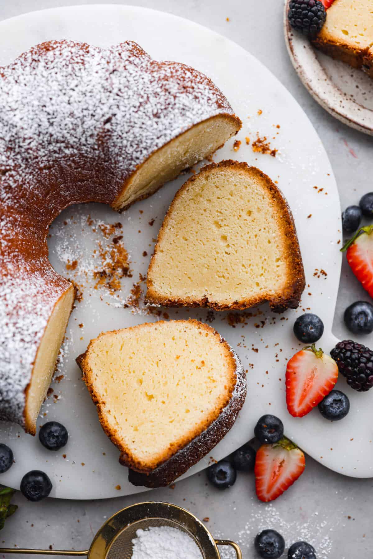 Top-down view of the cream cheese bundt cake with 2 slices cut out of it.