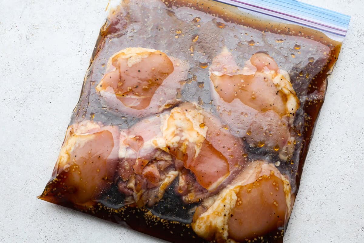 Chicken being marinated in a ziplock bag. 