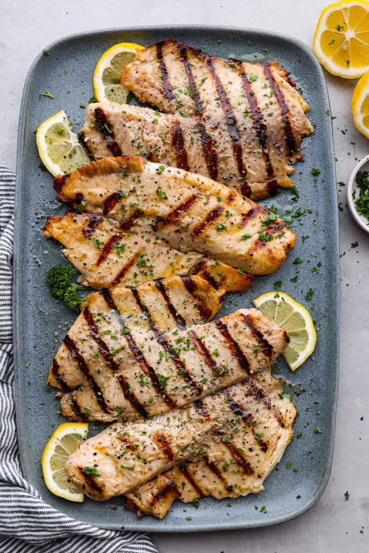 Top view of grilled tilapia on a platter. 