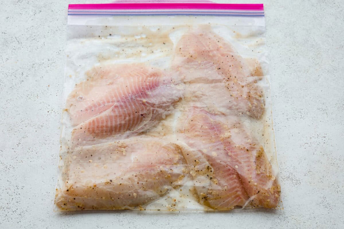 Tilapia in a ziplock bag with marinade. 