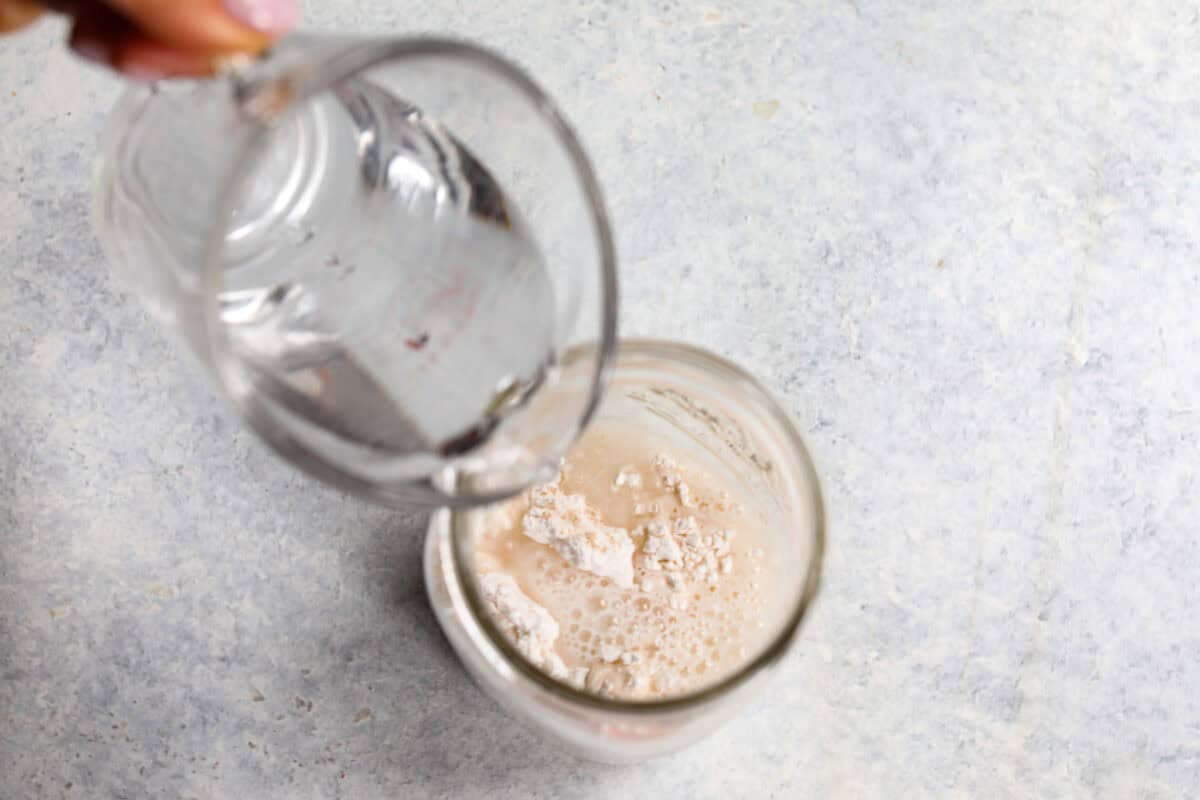 water being poured into yeast to show how to bake with it. 