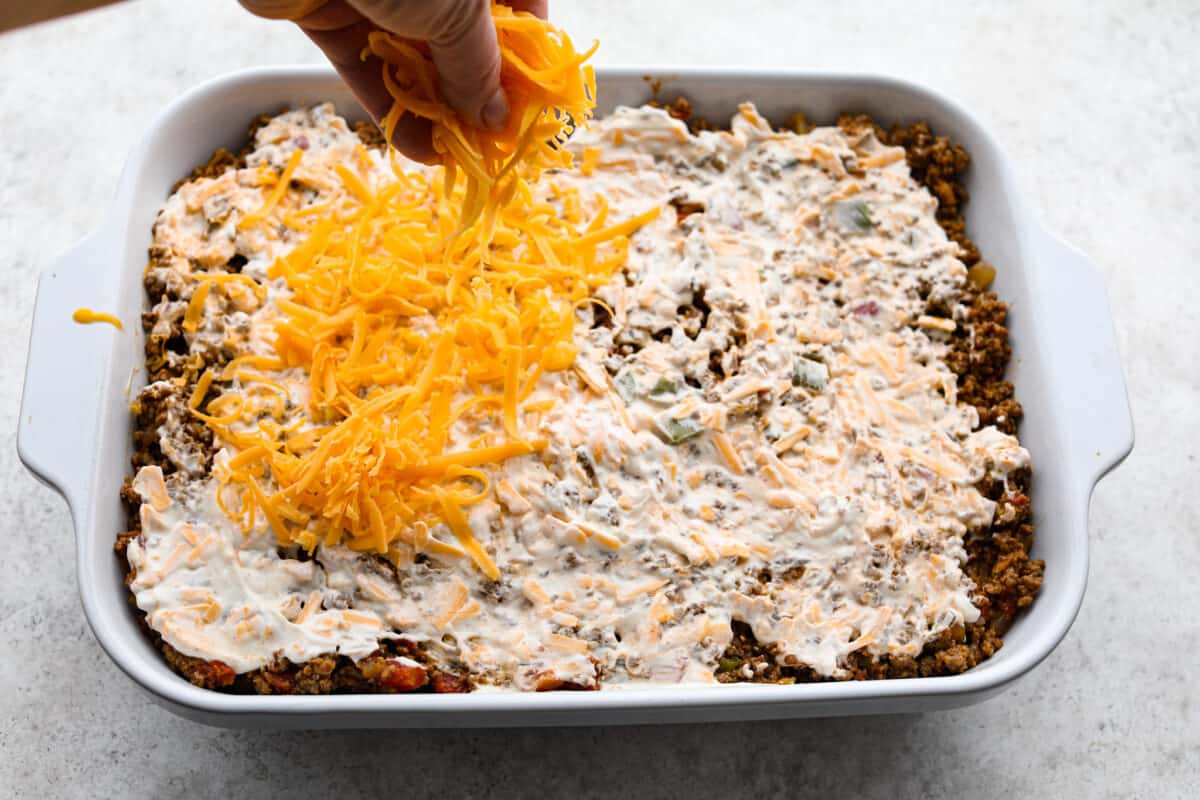 Cheese and mayonnaise mixture added to pan of John Wayne Casserole. 