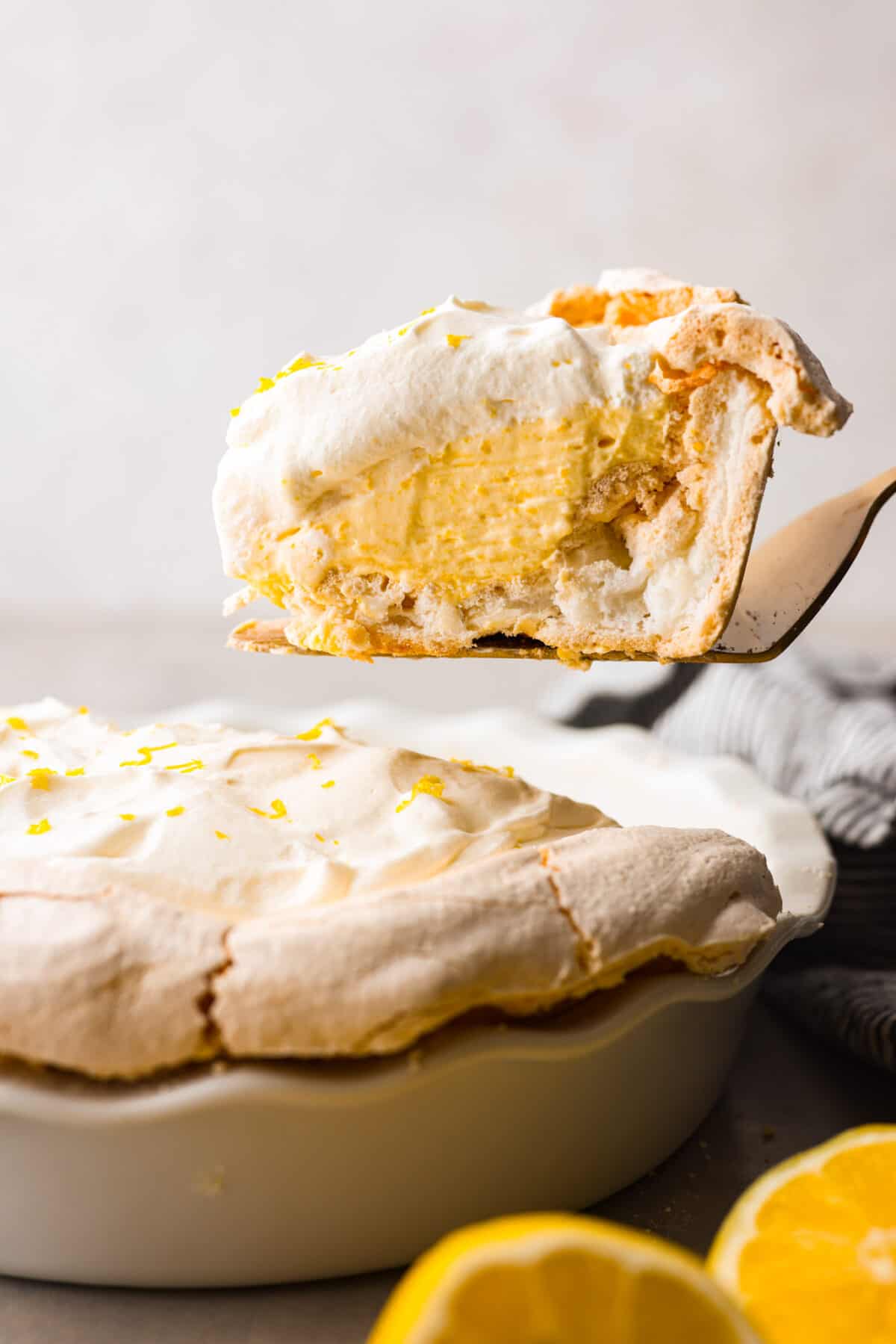 Close view of a slice of lemon angle pie on a serving spatula.