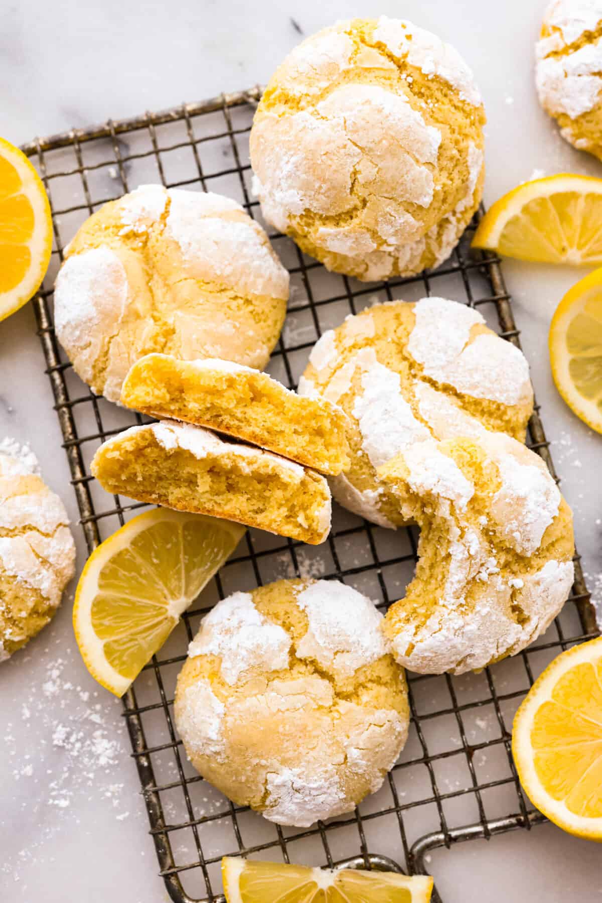 The crinkle cookies on a wire rack. Some have a bite taken out of them or are broken in half.