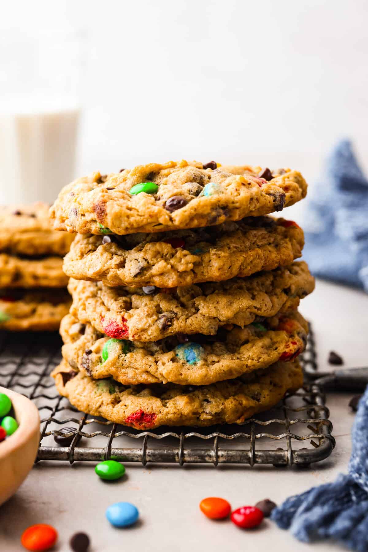 Close photo of monster cookies stacked on a cooling rack.