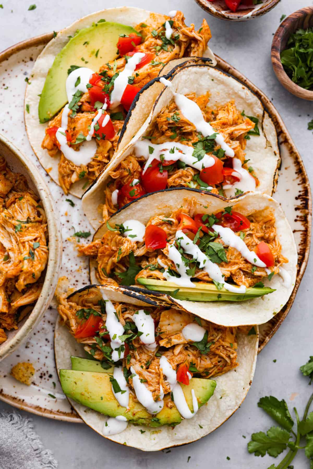 Top view of slow cooker ranch chicken tacos on a platter.