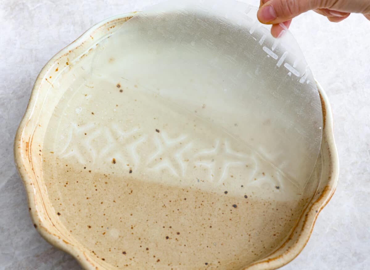 Rice paper being submerged into water. 