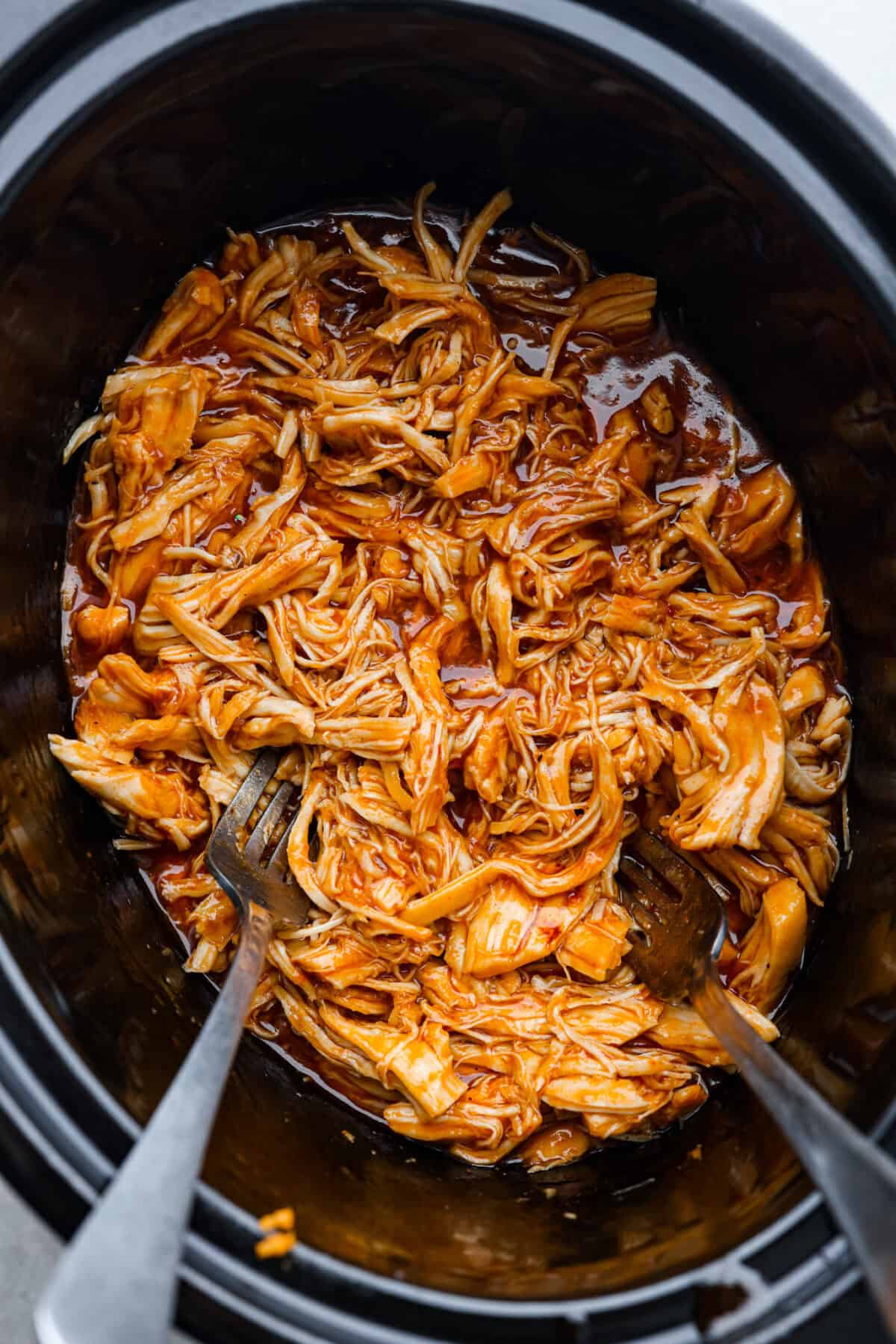 Top view of zesty bbq chicken shredded in the crockpot.