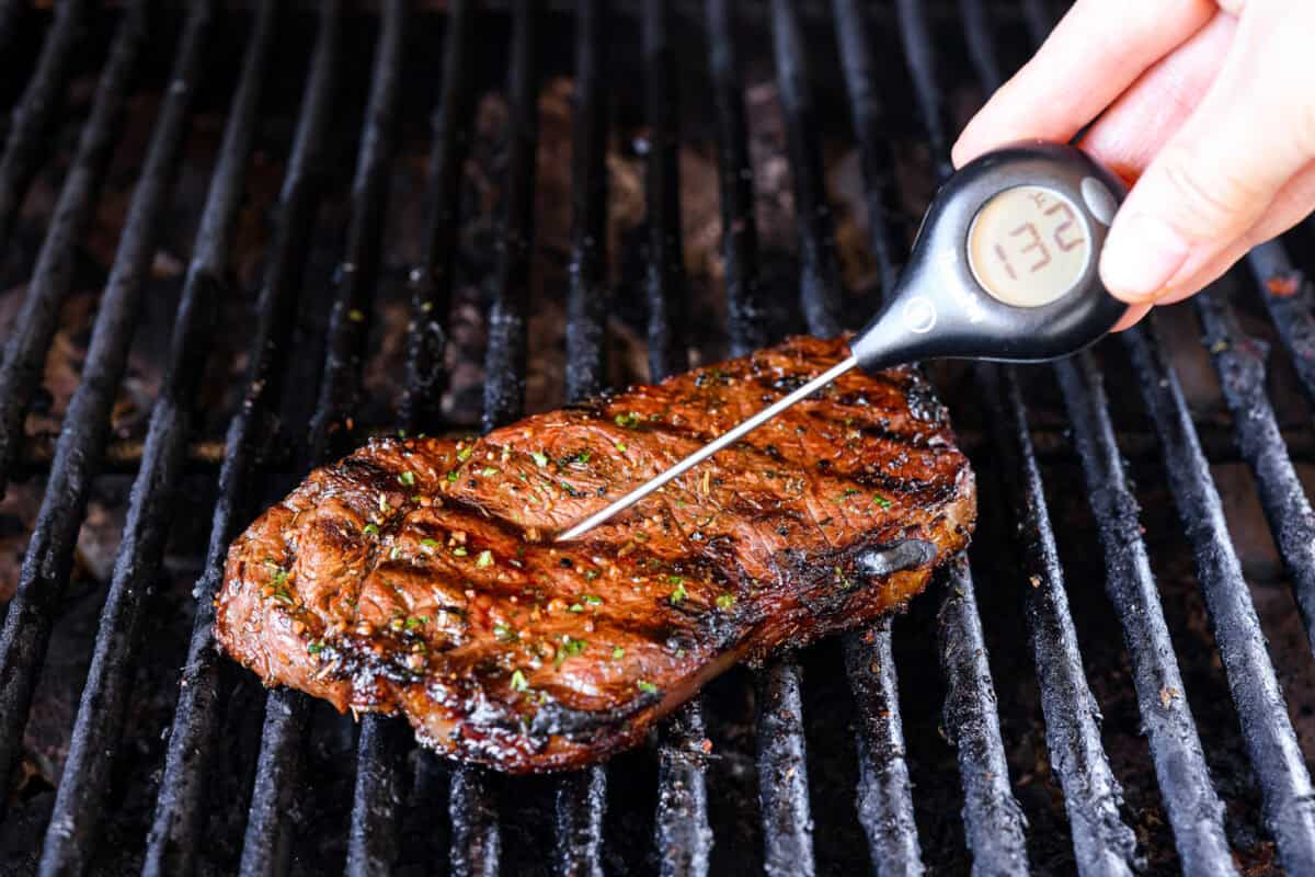 Second photo of taking the temperature of a steak.