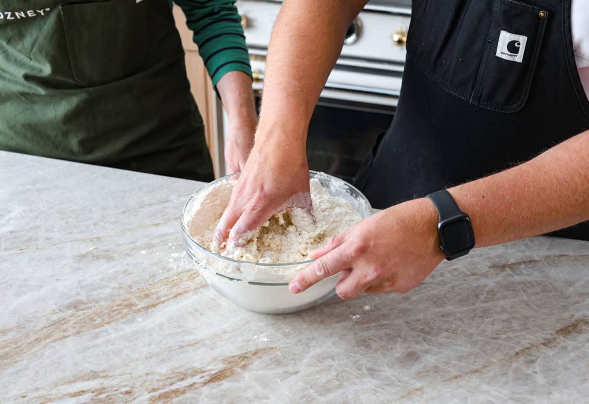 Fourth photo of mixing the dough with hands.