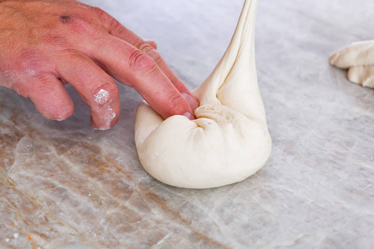 First photo of dividing and shaping the dough into balls.