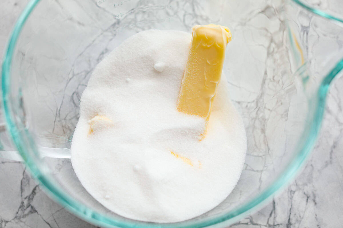 Butter and sugar in a glass bowl.