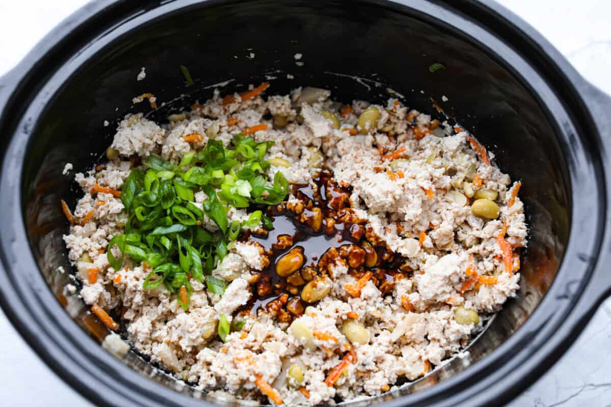 Overhead shot of crock pot with cooked lettuce wrap filling. 