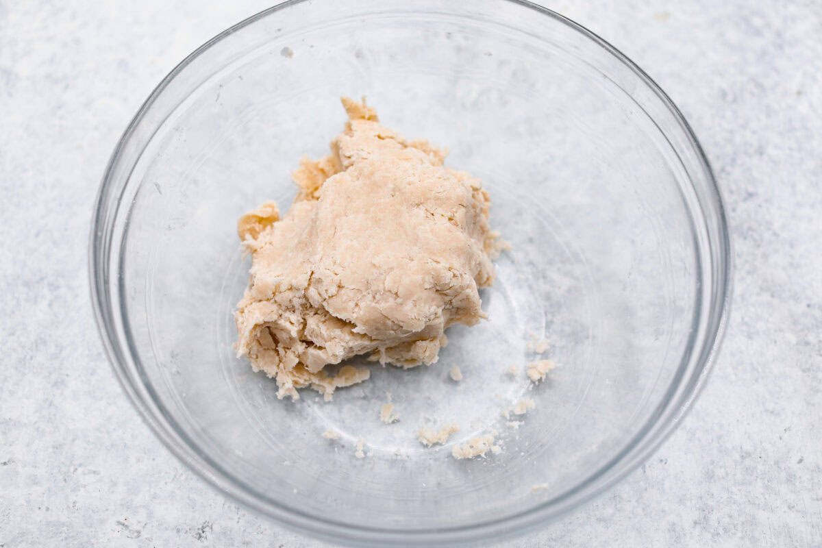 Overhead shot of crust dough in a ball in a bowl. 