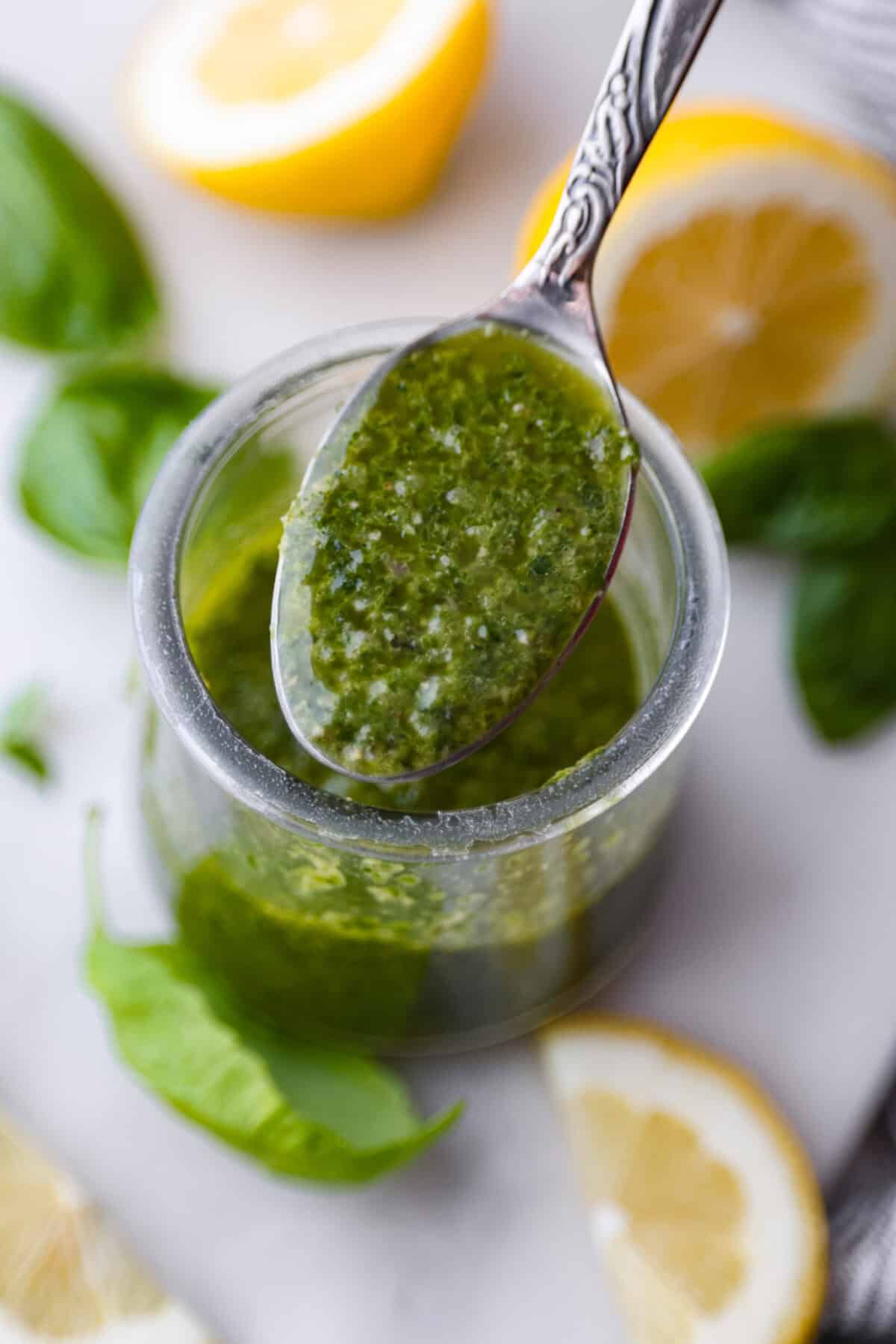 Close up shot of a spoonful of basil vinaigrette. 