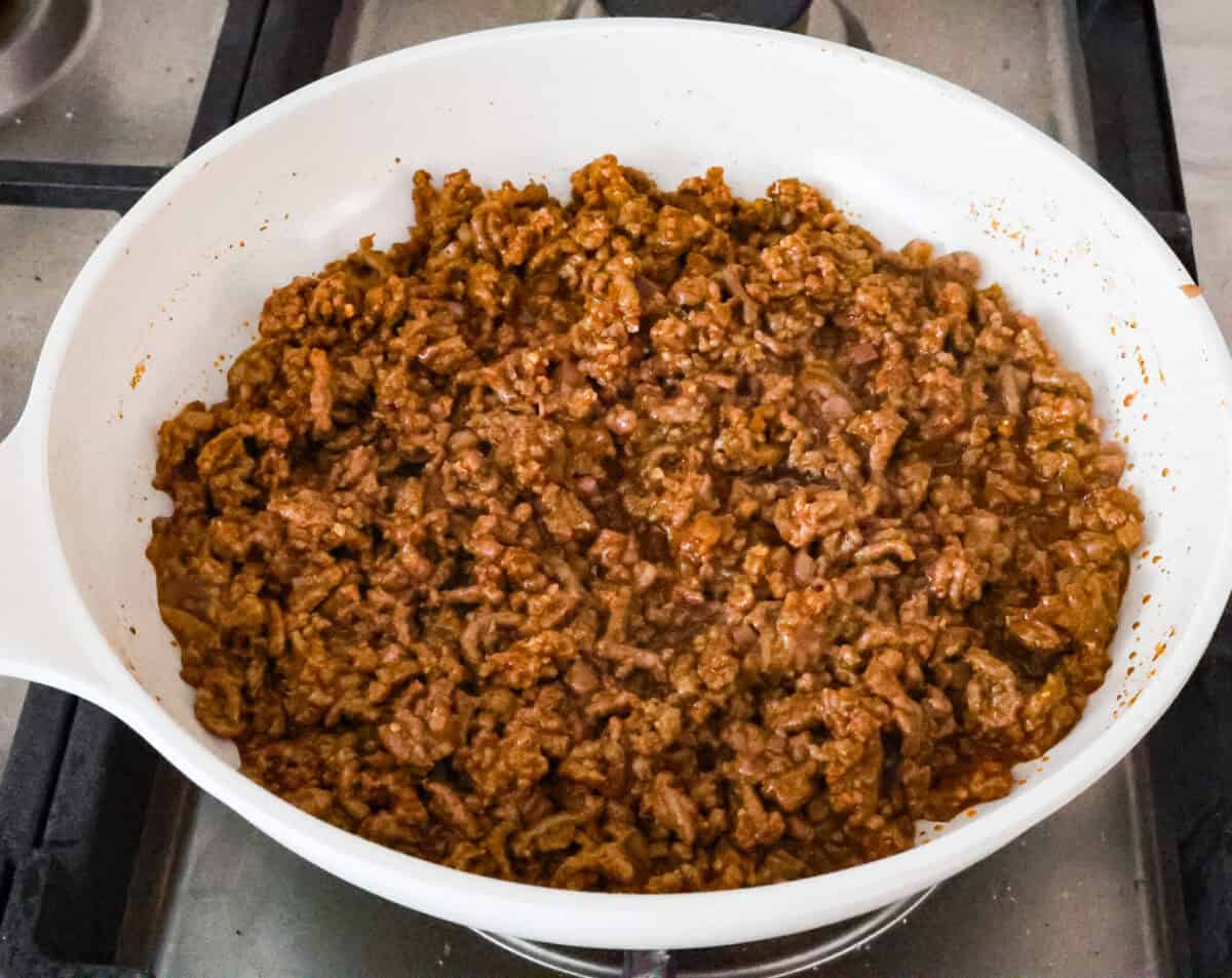 Angle shot of cooked and seasoned ground beef in pan. 