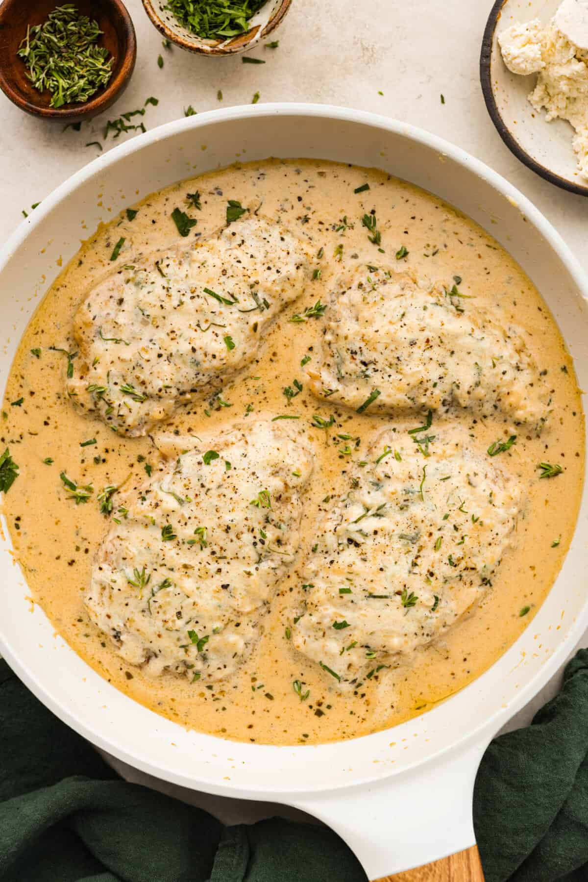 Overhead shot of cooked Boursin pork chops in pan.