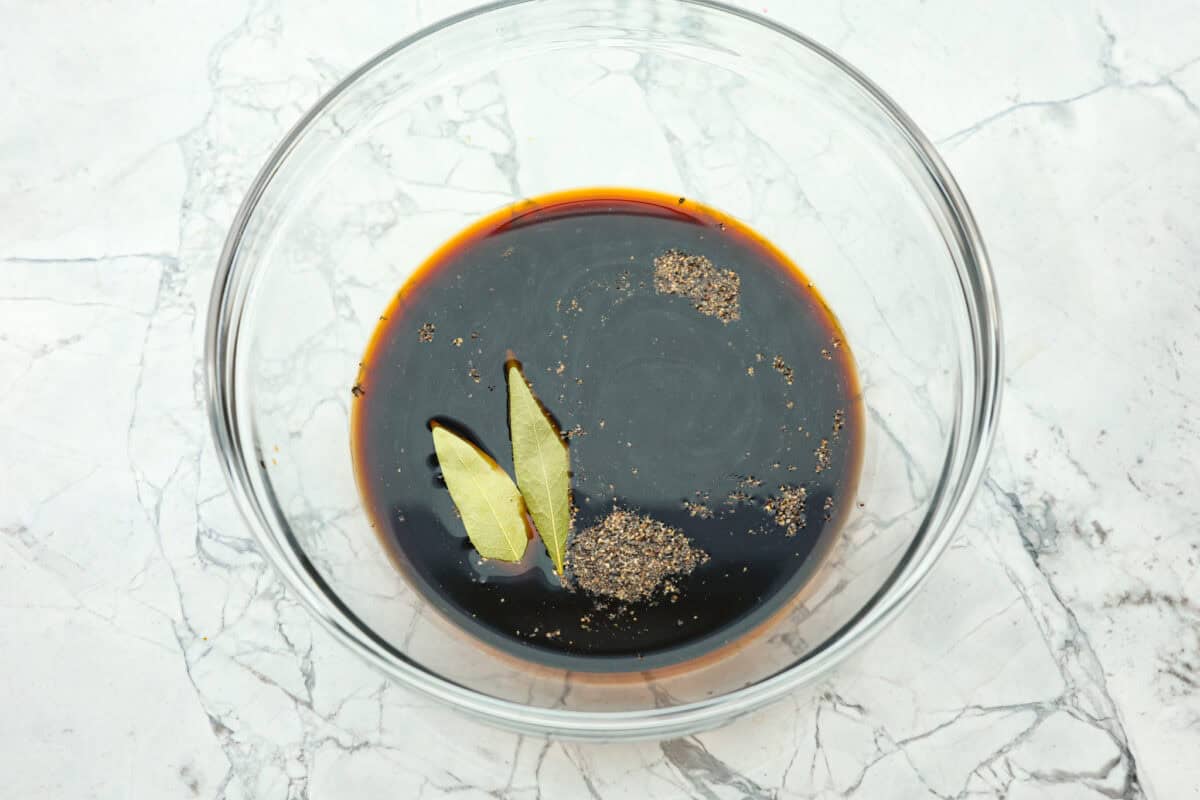 Overhead shot of marinade ingredients in large glass bowl. 