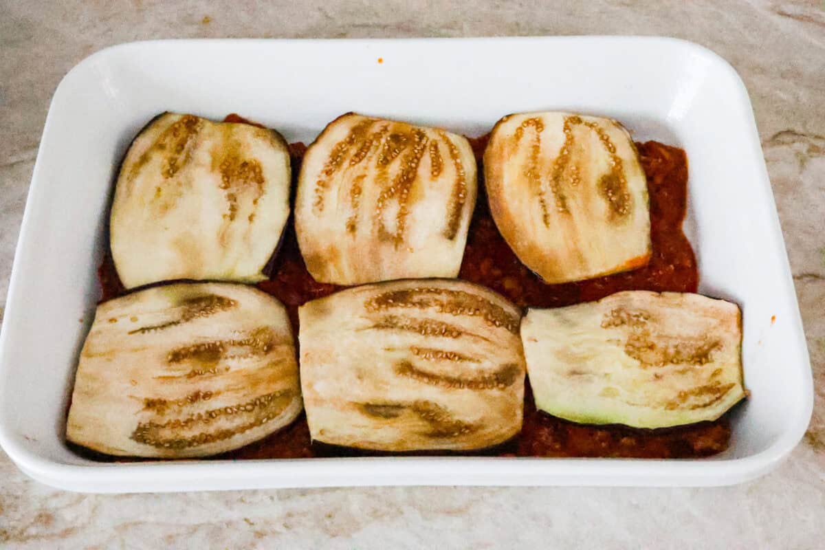 Fifth photo of the layering of the eggplant lasagna in the casserole dish.