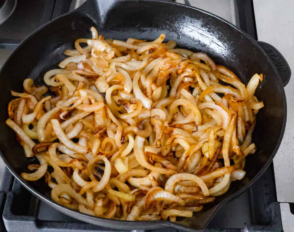 Overhead shot of grilled onion in skillet. 