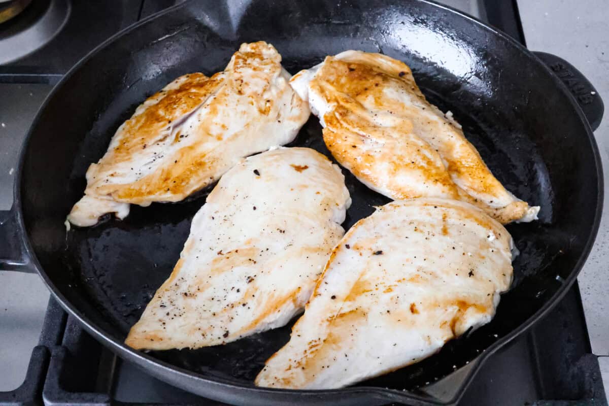 Overhead shot grilled chicken in a skillet. 