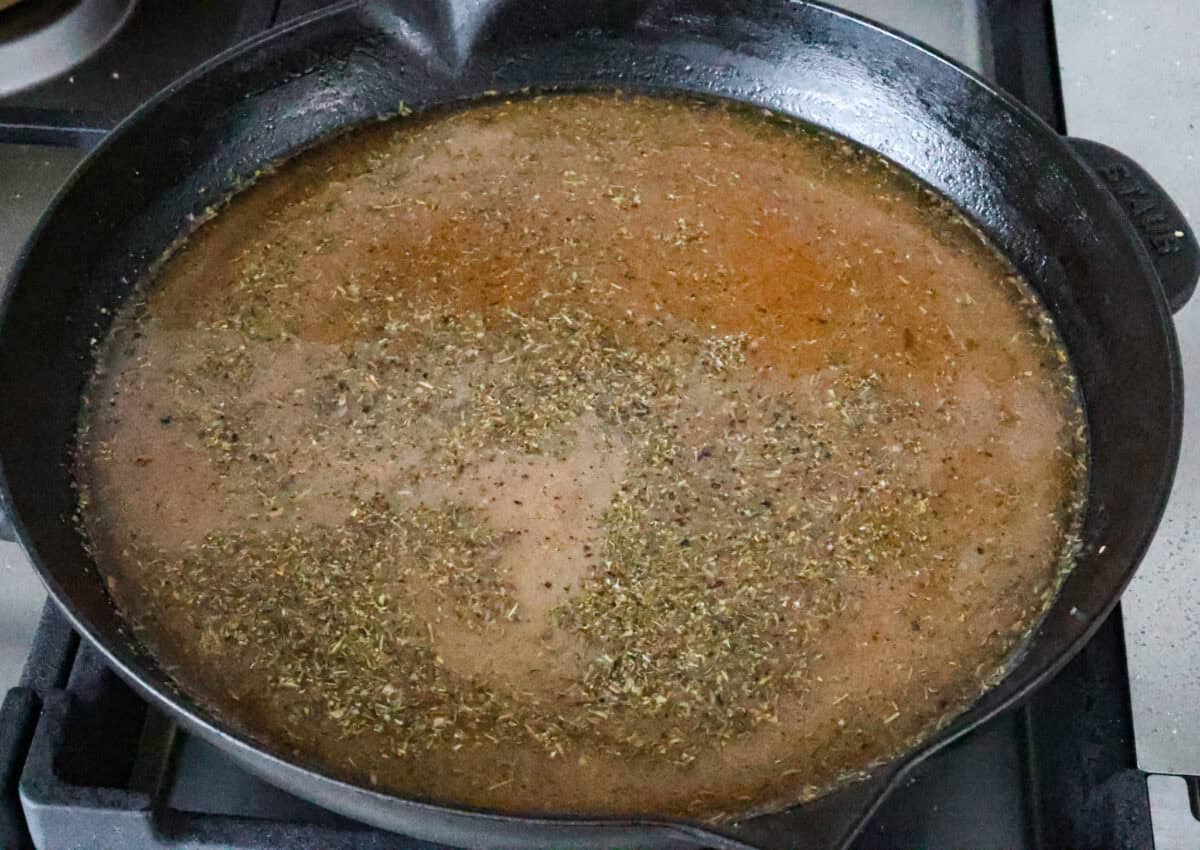 Overhead shot of uncooked sauce ingredients in skillet. 