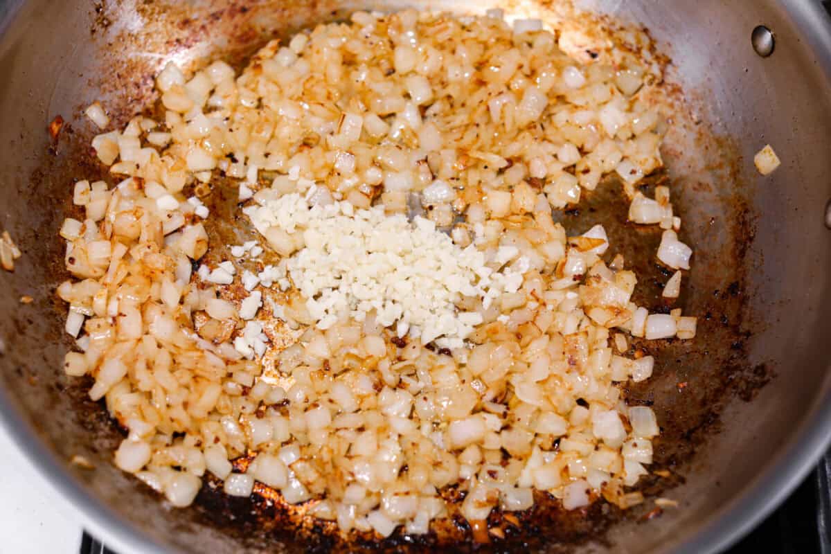 Second photo of the onion and garlic cooking in a pan. 