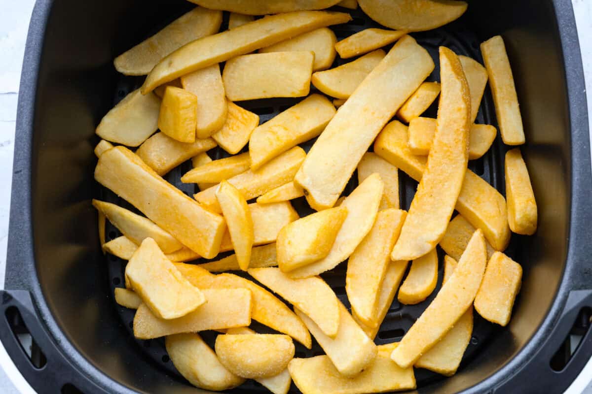 First photo of frozen French fries in a basket.