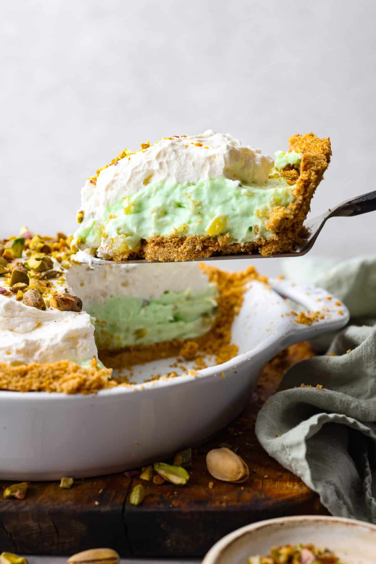 Close side view of a slice of pie lifting from the pie dish.