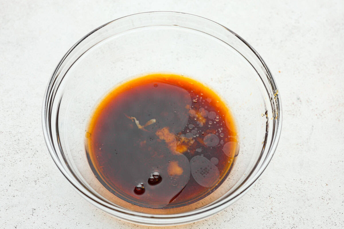 Overhead shot of a bowl of all the poke sauce ingredients dumped in a bowl. 