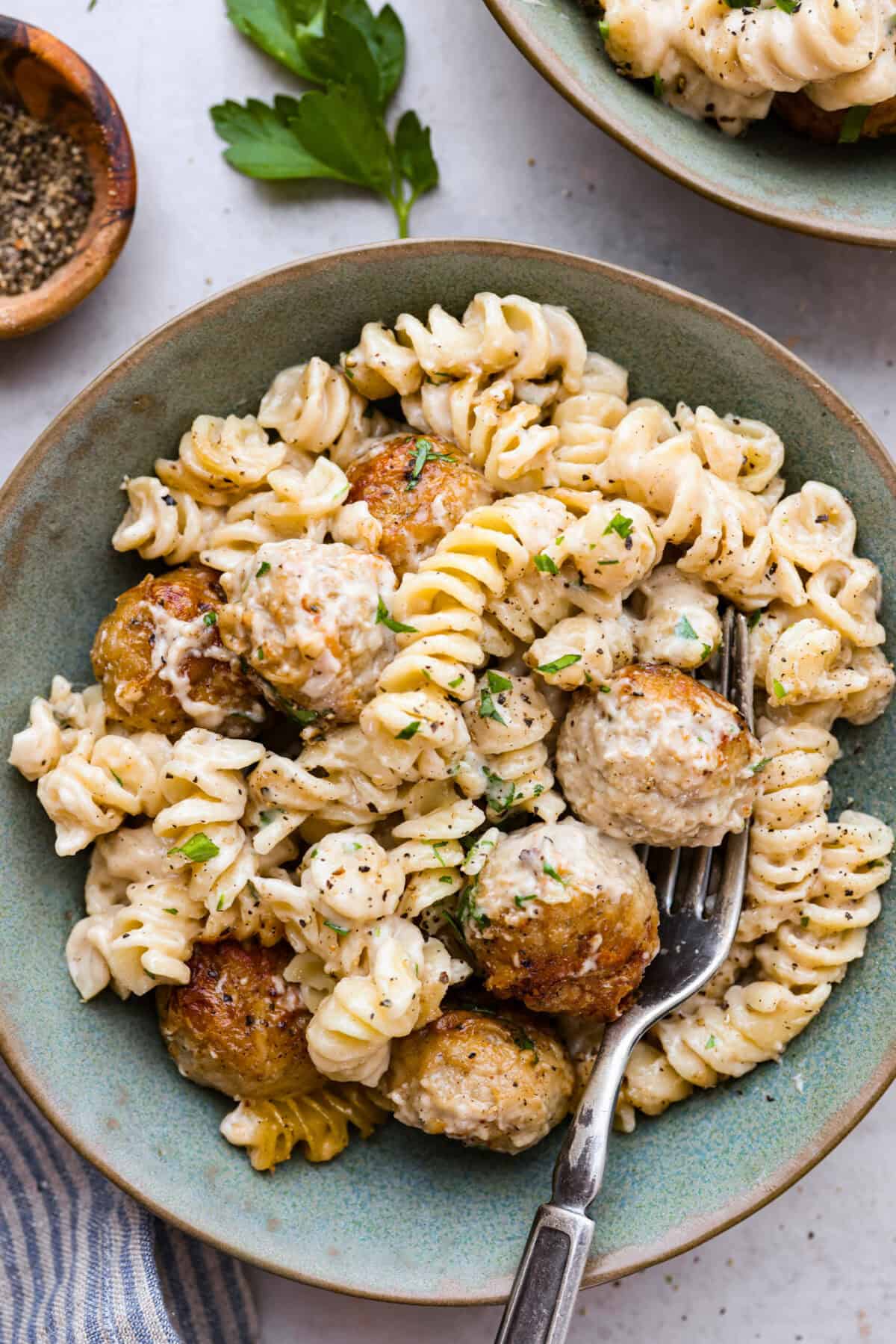 Overhead shot of a pile of plated Swedish meatball casserole. 