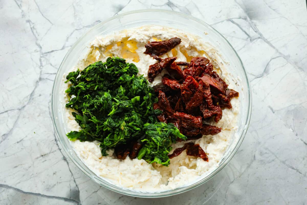 Third photo of the spinach and sun-dried tomatoes added to the bowl.