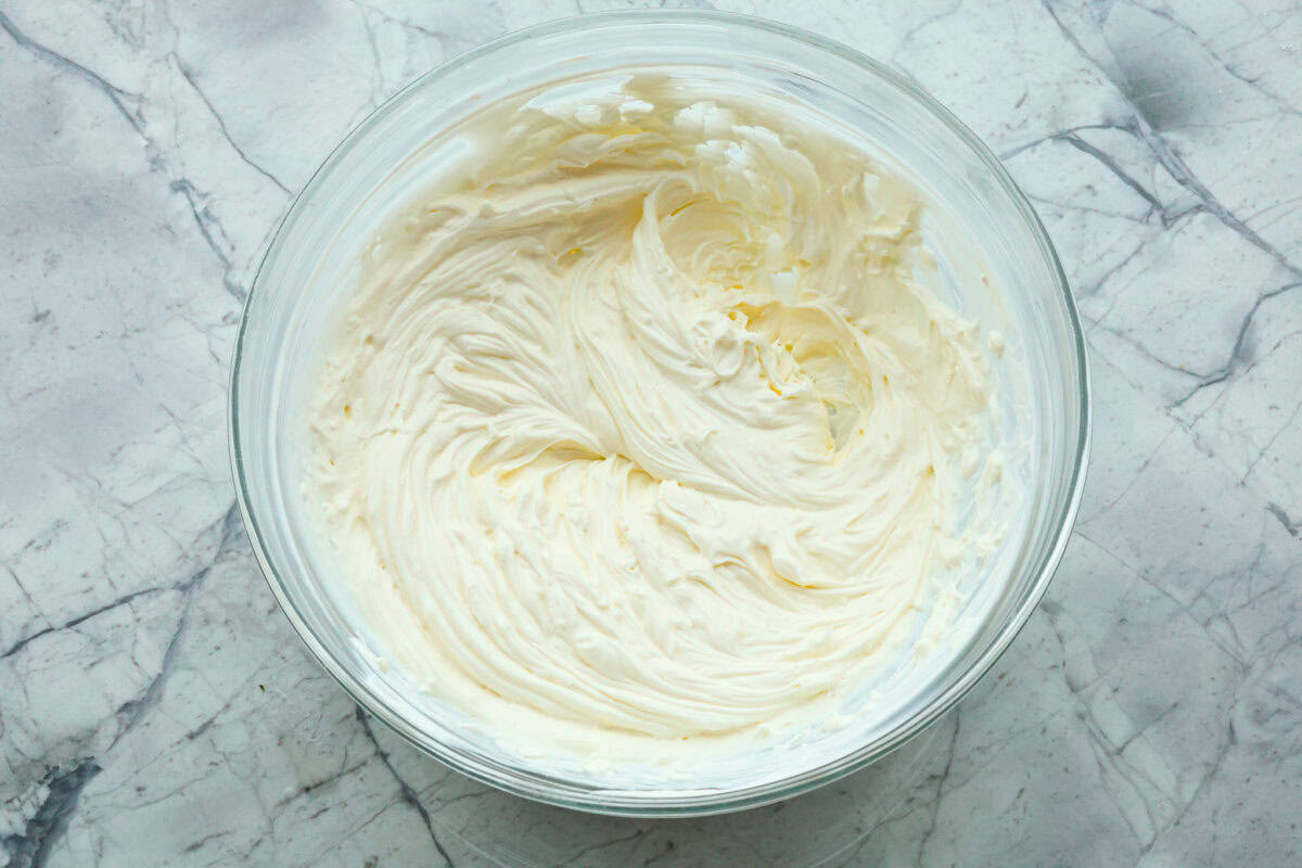 First photo of the cream cheese and sour cream mixed in a bowl.