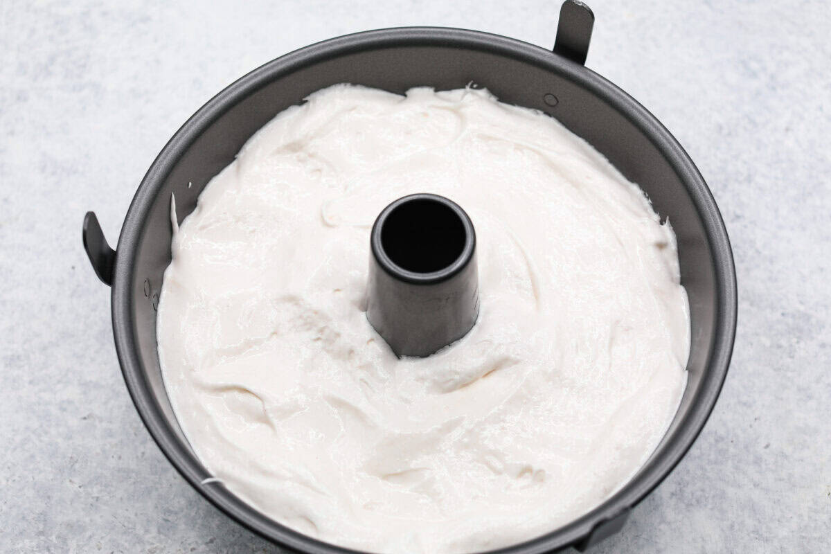 Overhead shot of angel food cake batter in tube pan. 