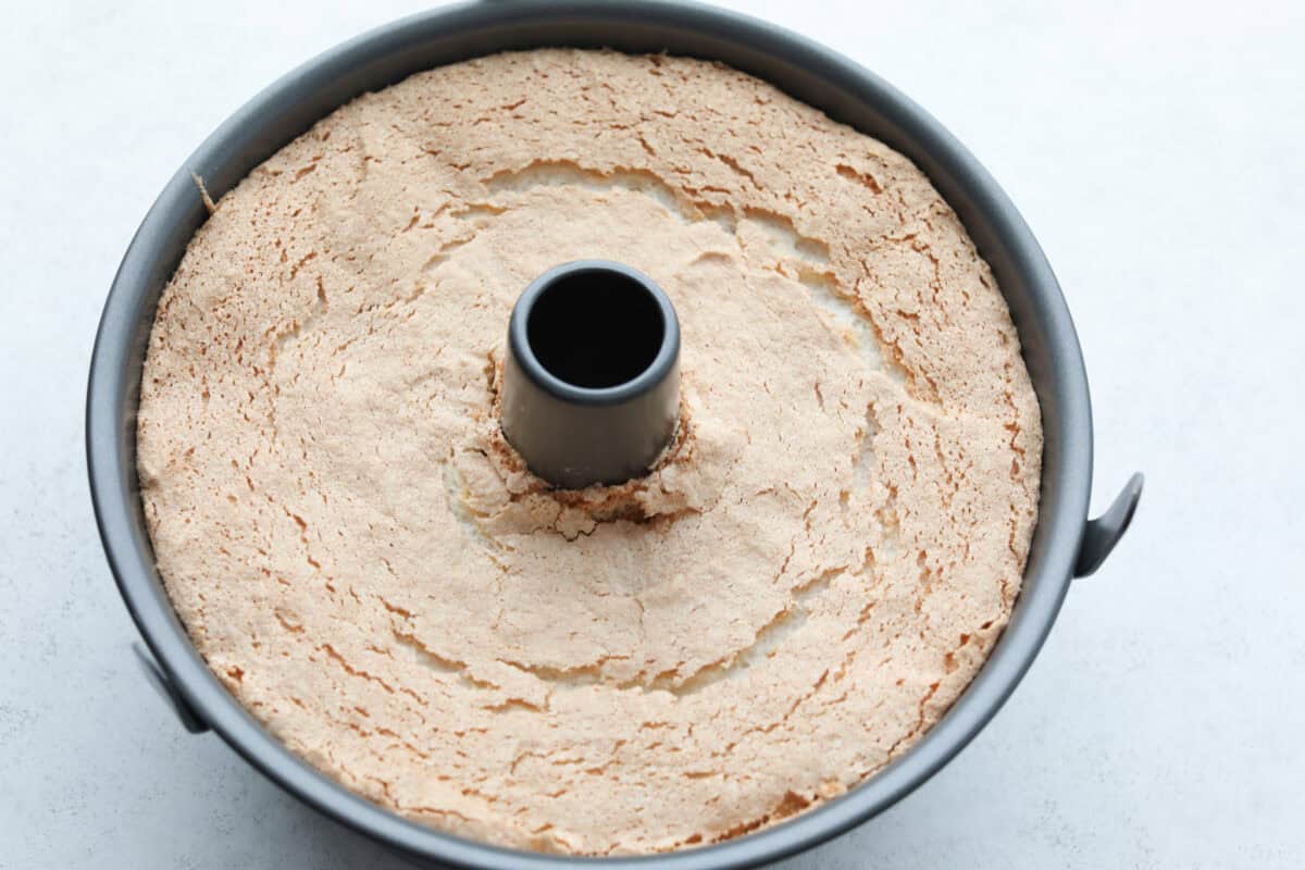 Overhead shot of bakes angel food cake in tube pan. 