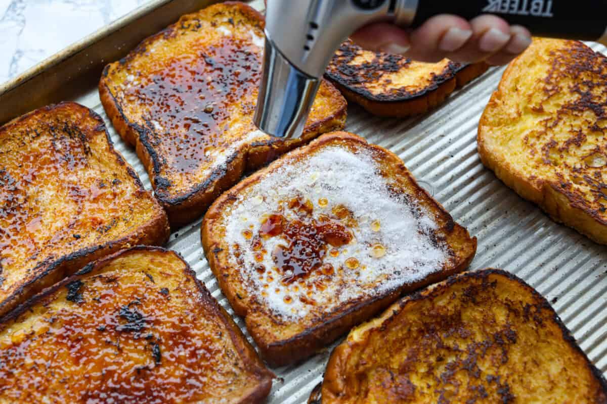 Sixth photo of the sugar being torched on top of the creme brûlée French toast.