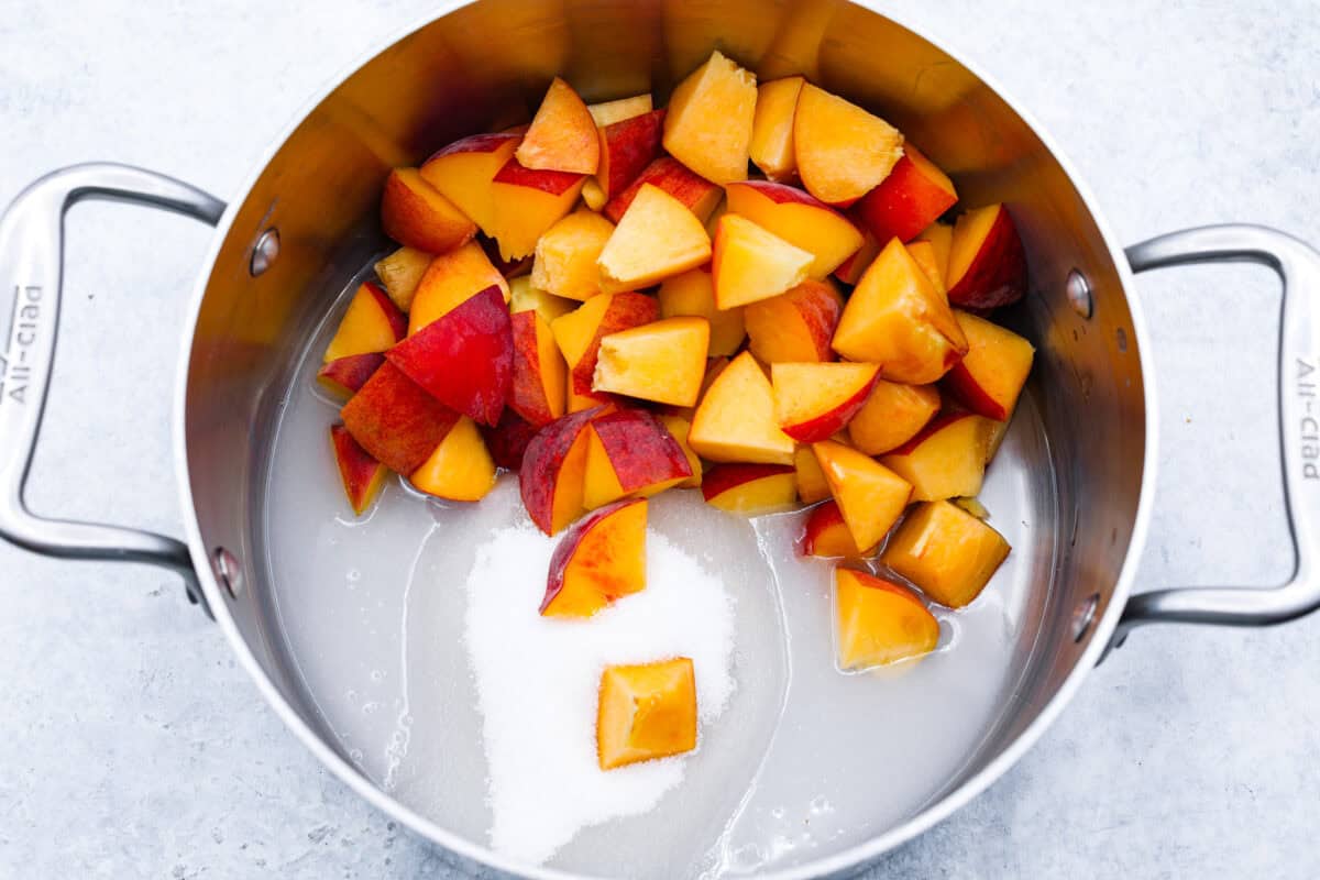 overhead shot of peaches with sugar and water in 