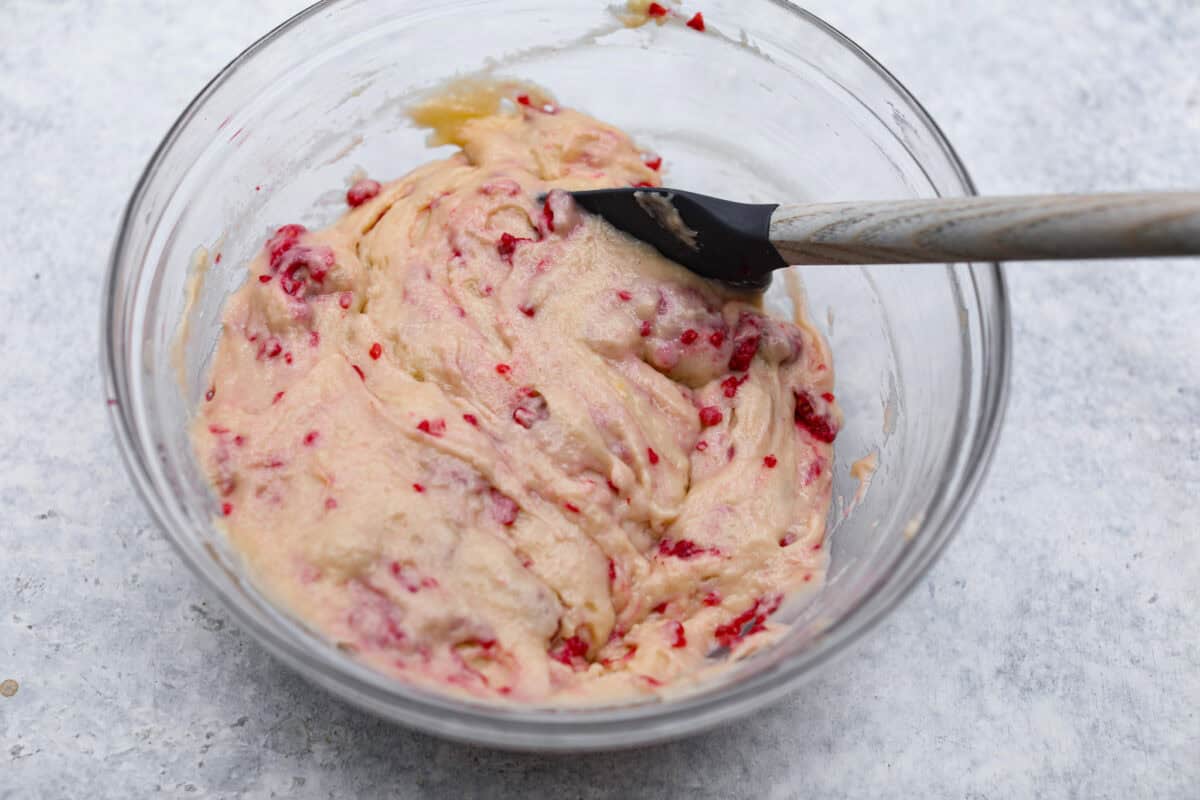 Overhead shot of raspberries folded into the muffin batter. 