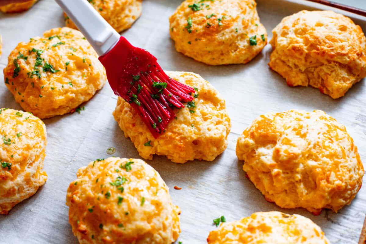 Fourth photo of the butter topping brushing on the red lobster cheddar bay biscuits.