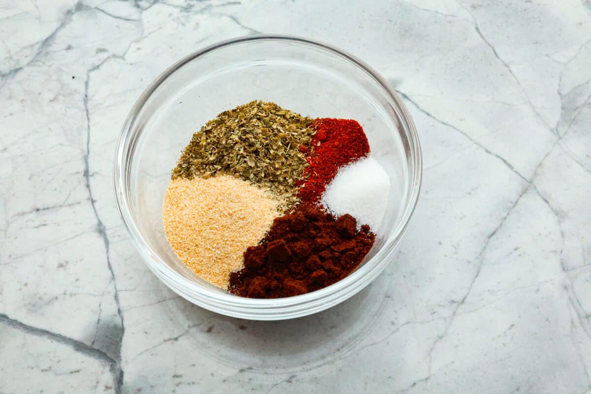 Overhead shot of ingredients separated in a glass bowl. 