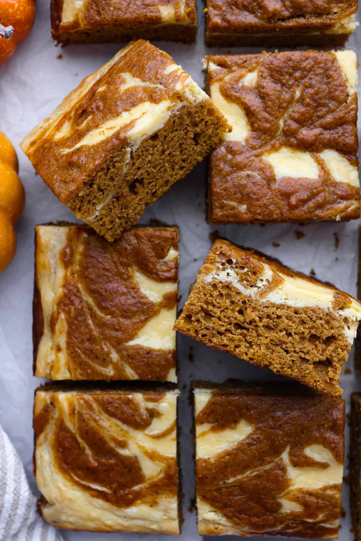 Close up shot of pumpkin roll bars on parchment paper. 