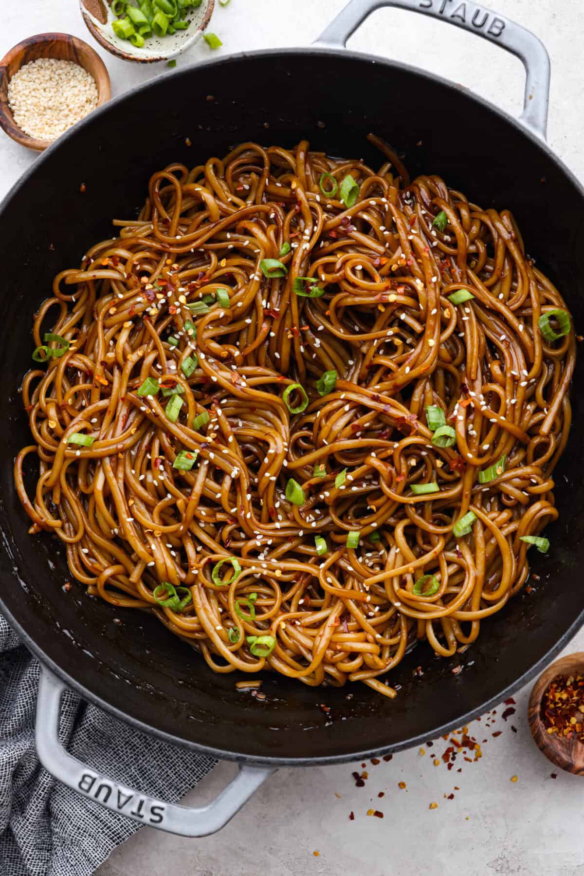 Overhead shot of cooked teriyaki noodles in a skillet. 