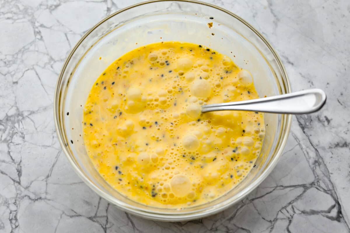 Overhead shot of egg mixture in a glass bowl. 