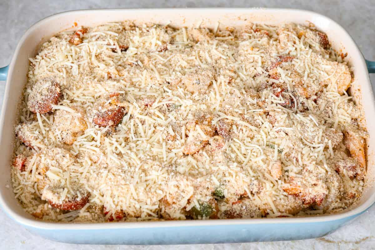 Overhead shot of casserole ingredients in a baking dish with breadcrumb topping sprinkled over the top. 