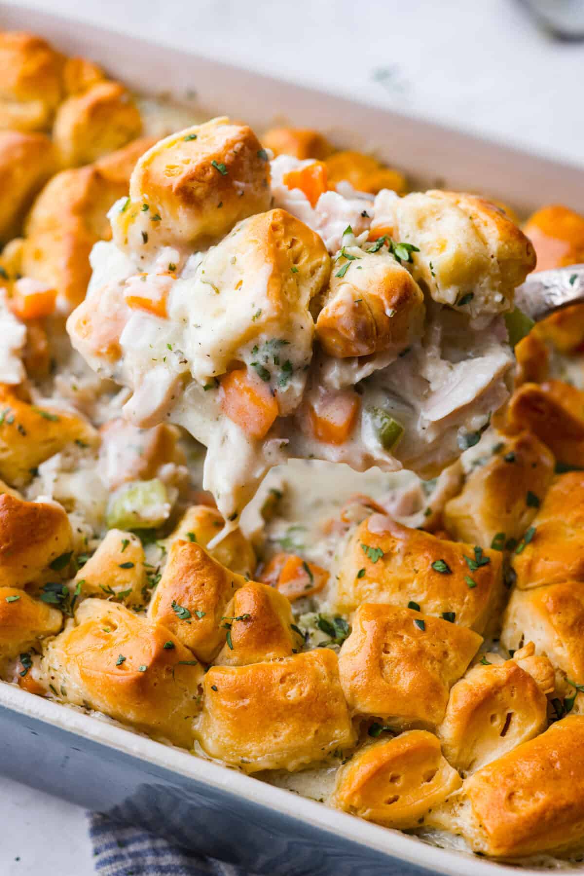 Close up shot of a scoop of chicken pot pie casserole. 