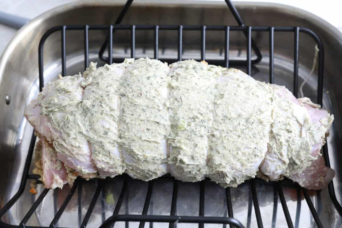 Seventh photo of the turkey roulade in a roasting pan to bake.