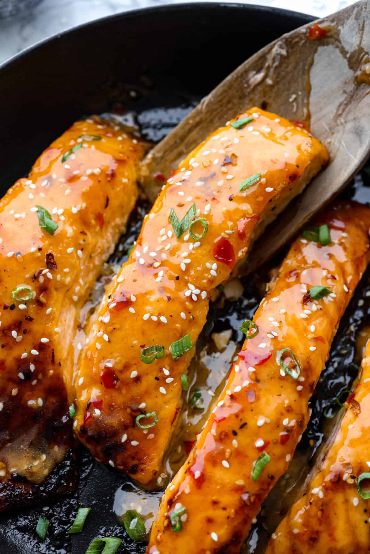 Overhead shot of bang bang salmon in a skillet. 