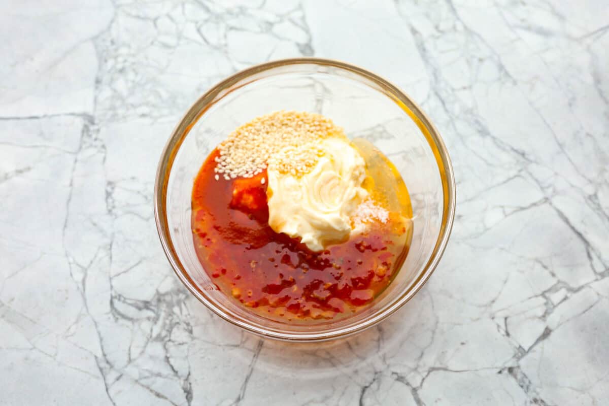 Overhead shot of sauce ingredients in a glass bowl. 